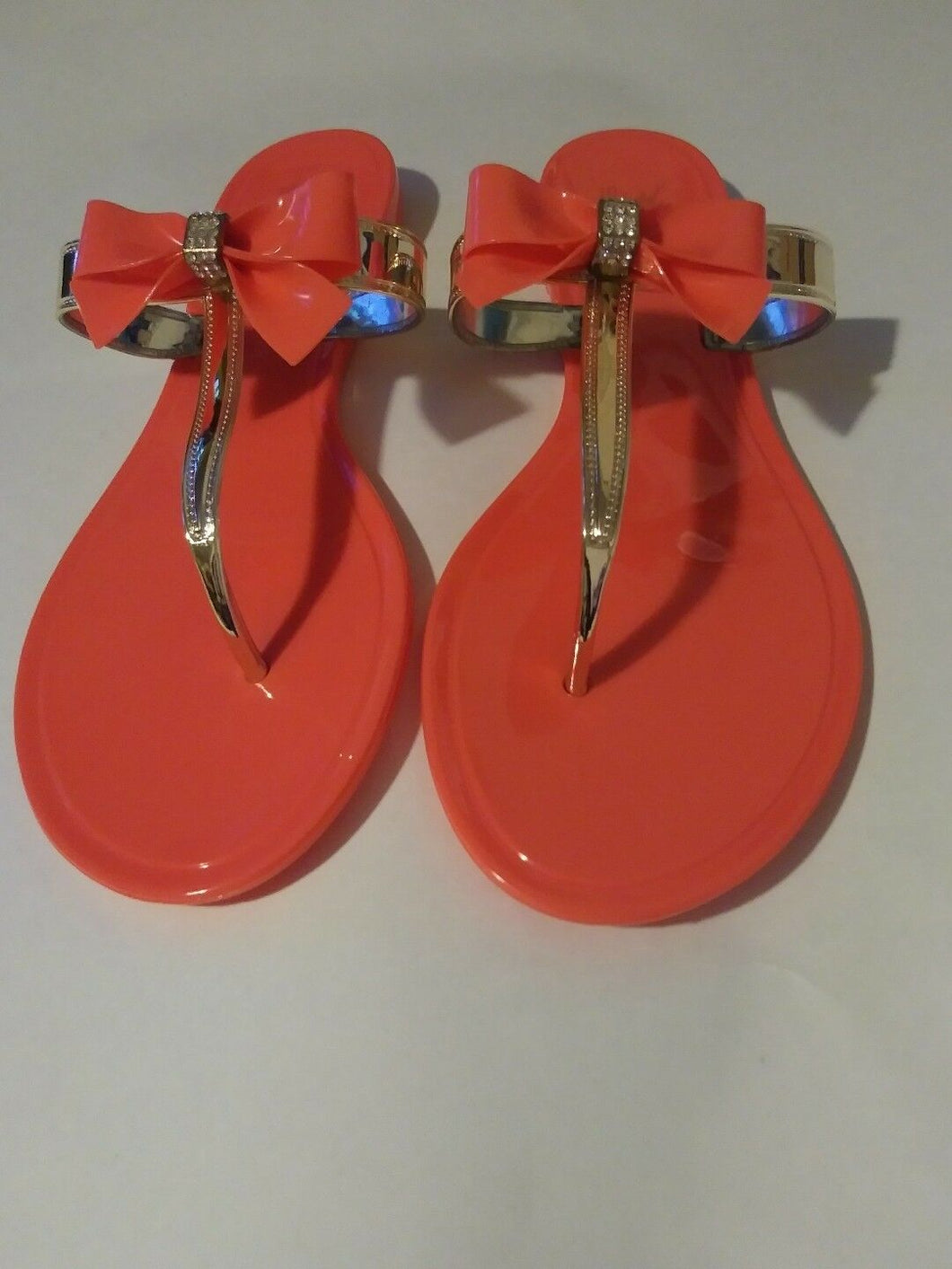 Womens Orange Jelly Flat Sandals with a Rhinestone Bowtie
